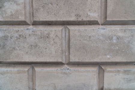 Close up of historical white old structured facade with rectangular shapes to use as backgroundの写真素材