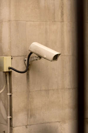 Close up of white surveillance camera mounted on facade ccd video surveillance security and...
