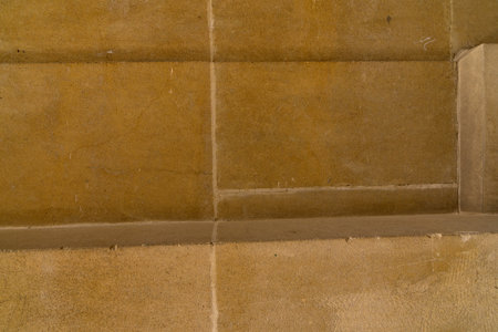 Close up of historical plane sandstone wall facade with rectangular shaped block to use as architectural backgroundの写真素材