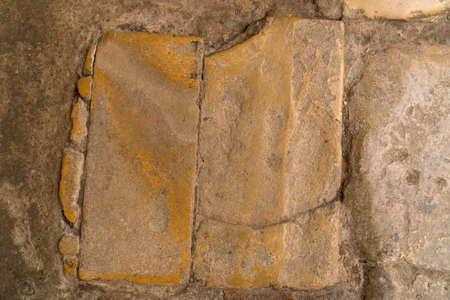 Worn smooth colored natural stone slab in an antique old heavily used stone floor from roman periodの写真素材