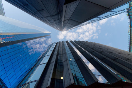 view up between high rise skyscraper buildings in downtown city center of London financial districtの写真素材