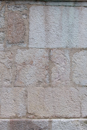 Close up white beige historic old structured bricked facade wall as background with stone blocks rectangular shapedの写真素材