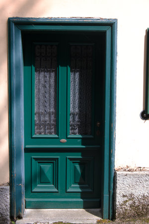 close-up of an old green structured entrance door as a concept for coming home welcoming and invitingの写真素材