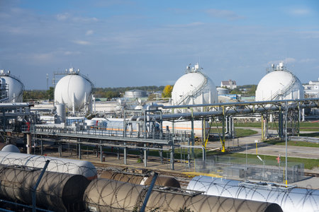 Large round storage tanks in a modern fossil fuel oil refinery as concept for fuel storage an non-renewable energyの写真素材