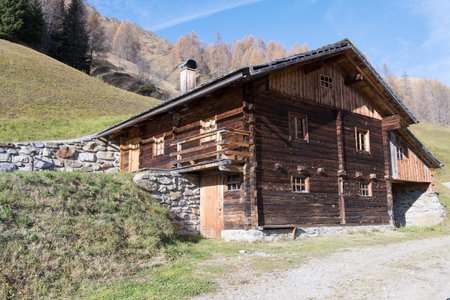 Close-up of a very old wooden house burnt by the sun in Innervillgratten East Tyrol as a concept for simple life in nature the mountains back to the origin and simplicityの写真素材