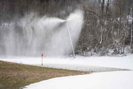 Snow cannon lance gun to produce artificial snow in ski resorts and on the slopes in front of...