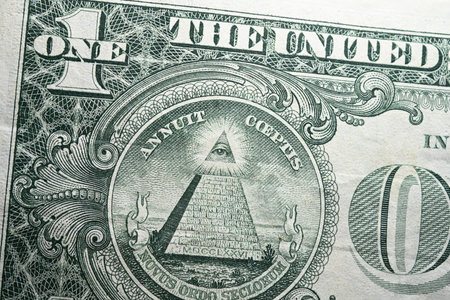 Detail extreme close-up of a one dollar banknote with clearly visible pyramid lifted capstone and all-seeing eye as concept for conspiracy theories Illuminati Masonic lodges and new world orderの写真素材