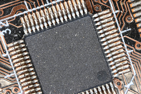 brown computer board extreme closeup view with visible solder joints and a big chip offering copy space as a concept for PC microelectronic electronics Internet and modern technologyの写真素材