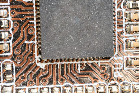 extreme close up detail partial view of a brown computer board with visible solder joints and chip offering copy space as concept computer tech chip electronics internet and modern technologyの写真素材