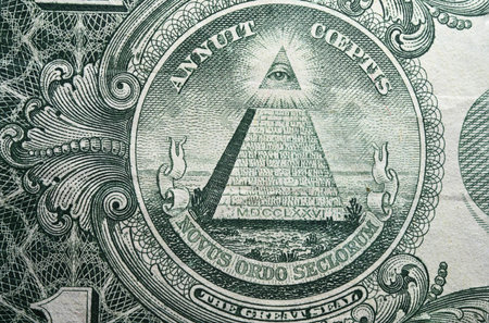 Partial view one dollar banknote money extreme detail closeup of visible capstone lifted all seeing eye on pyramid as concept conspiracy theories about Illuminati ne world order and Masonic lodgesの写真素材