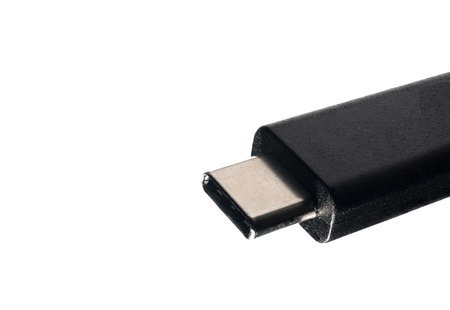 Extreme closeup black and silver USB-C cable plug with copy space on white background concept for standardized charging cell phone and standardized electronic plugsの写真素材