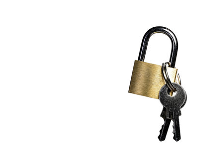Close up of small brass gold metal steel padlock shackle lock with attached keys on white background as concept for security locker and safetyの写真素材