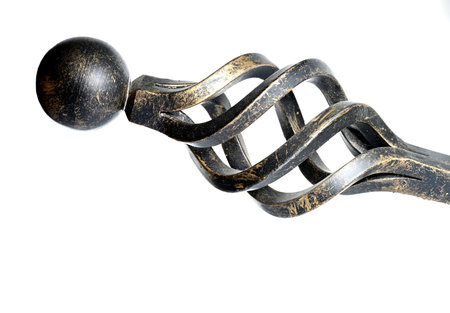 Close up of ornate curved forged finial of wrought iron curtain rod rail bar as concept for art forgingの写真素材