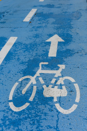 blue lane marked with paint bike lane with white lines and painted arrow for the direction plus cycle as concept for bicycle lane bike traffic and transportation and cyclingの写真素材