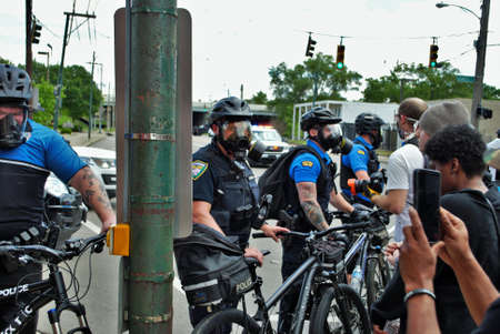 Dayton, Ohio United States 05/30/2020 police officers putting on gas masks preparing to deploy OC...