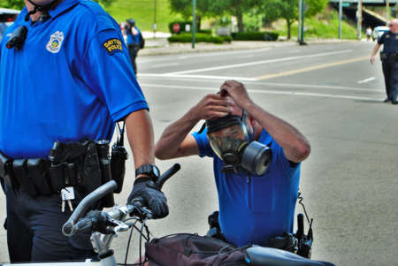 Dayton, Ohio United States 05/30/2020 police officers putting on gas masks preparing to deploy OC pepper spray and tear gas at a black lives matter protestのeditorial素材