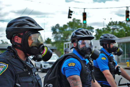 Dayton, Ohio United States 05/30/2020 police officers putting on gas masks preparing to deploy OC pepper spray and tear gas at a black lives matter protestのeditorial素材