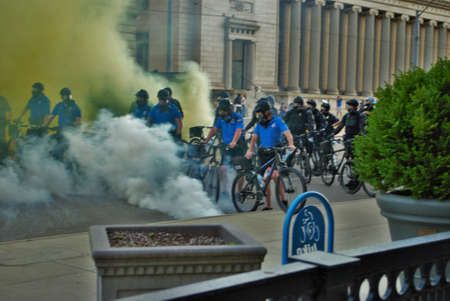 Dayton, Ohio United States 05/30/2020 police and SWAT officers through a cloud of tear gas at a...