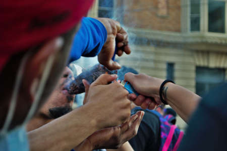 Dayton, Ohio, United States 05/30/2020 protesters at a black lives matter rally lighting and smoking a gigantic bluntのeditorial素材
