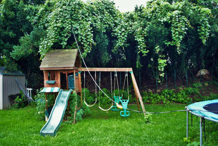Dangerous live downed power line draped across trampoline and backyard playground
