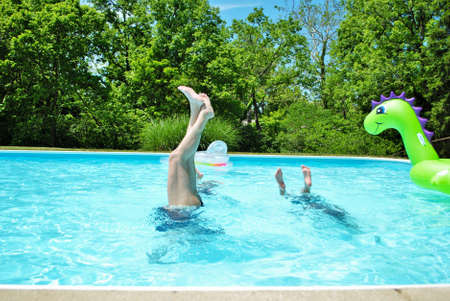 Mother and daughter doing handstands in the pool