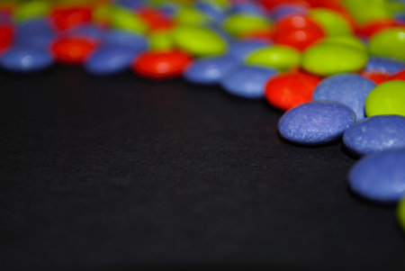 Colorful Halloween candy background orange blue green purple candy coated milk chocolate room for text copy spaceの写真素材