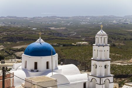White church in front of Santorini's landscape, Greeceの写真素材