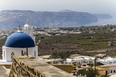 White church in front of Santorini's landscape, Greeceの写真素材
