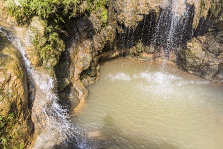 Small waterfall above water pool in Indonesia