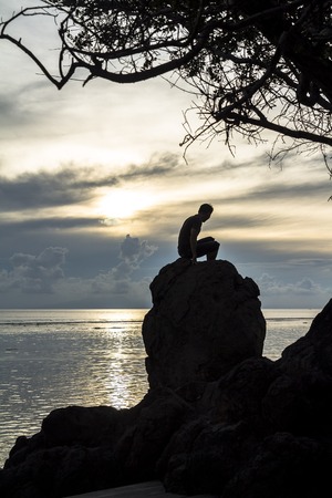 Silhouette of man on the sea, Gili Islands, Indonesiaの写真素材