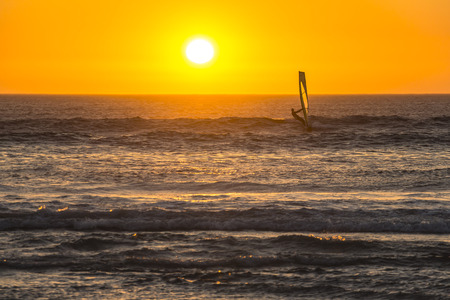 Kitesurfer surfing in the sunset on beach in Cape Townの写真素材