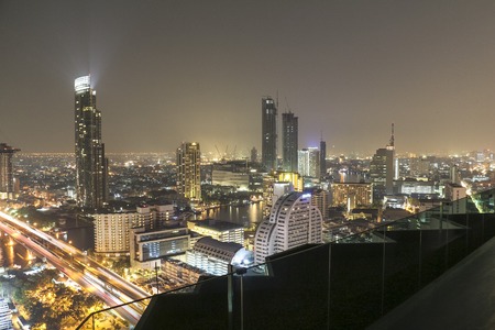 Infinity pool in Bangkok at night with view of the cityscape