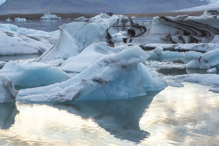 Eisbergs in glacier lagoon Jokulsarlon before sunset, Iceland