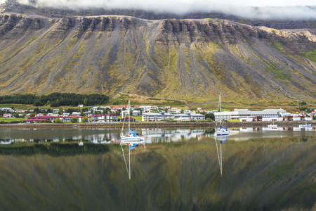 Fjord and boats reflection at Isafjordur town, Icelandの写真素材