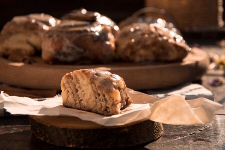 Cinnabon buns with cinnamon on a wooden boardの写真素材
