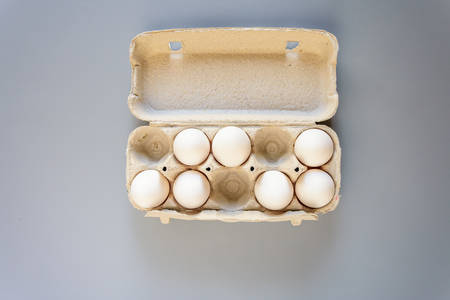 White fresh eggs on gray background. Rural still life, natural organic healthy food with free space. Close upの写真素材