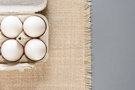 White fresh eggs on gray background. Rural still life, natural organic healthy food with free space....