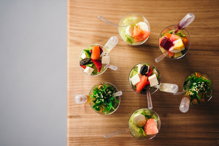 Mini fresh salads with sauce. Top view. Catering - served table with appetizersの写真素材