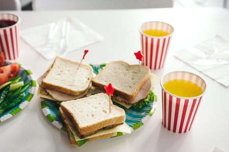 Delicious sandwiches with turkey and cheese for kids party. Beautifully decorated foodの写真素材