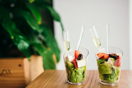 Two mini greek salad with sauce. Selective focus.の写真素材