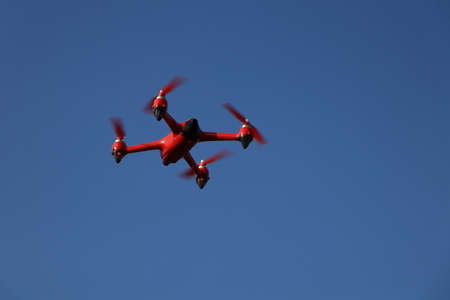 red drone on a blue sky backgroundの写真素材
