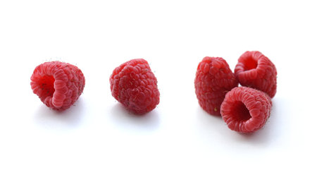 Fresh raspberries closeup, isolated on white background, with shadows. Bright red sweet juicy...