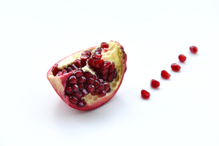 One half of juicy ripe pomegranate fruit on a white background close-up.Pomegranate Isolated Whole Pomegranate slices Red Healthy on a white background.の写真素材