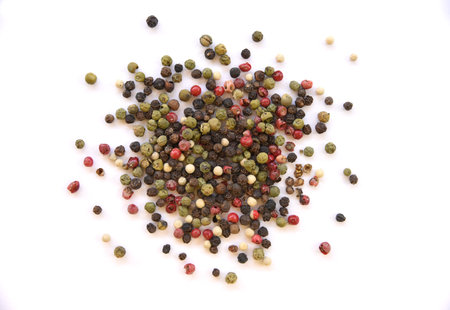 Colorful peppercorn mix isolated on white background, closeup. Scattered whole black, white, green,...
