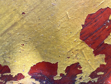 Grunge background texture, yellow peeling paint exposes old cracked varnish on tinted wood. Worn out, aged, damaged vintage lacquered furniture surface with rough, bubblingの写真素材