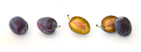 plums isolated on white background with shadows. A set of whole ripe fruits in blue, purple color...