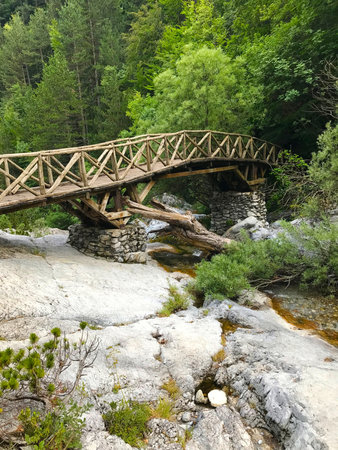 Old wooden bridge over mountain stream, Mount Olympus, Greece. beautiful places in Greece. Old...