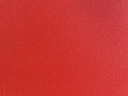 Rough surface. Grunge texture as background. Uneven red outer wall with small, frequent cracks. Durable rough cement or concrete plaster. Painted pebbles. Uneven structural plasterの写真素材
