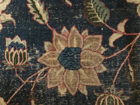 Seamless pattern of golden flowers and stripes on a dark background. Handmade carpet. Surface...