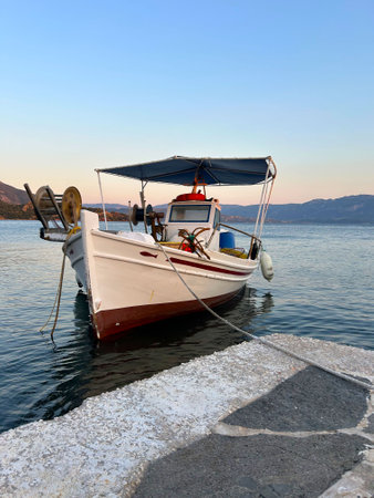 Traditional Greek fishing boat with fighing nets in the aegean sea, Greece.